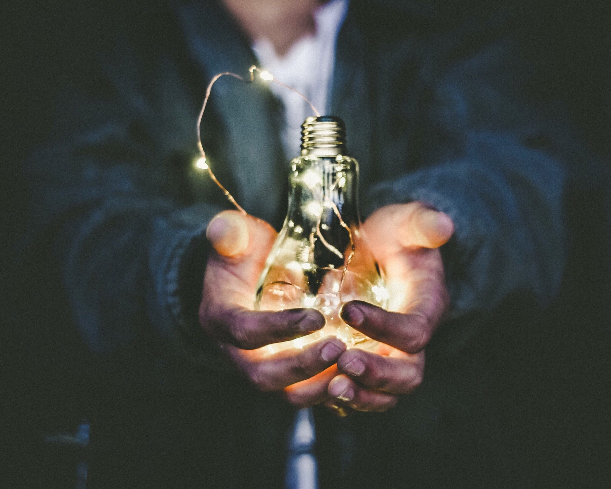 glowing light bulb in hands